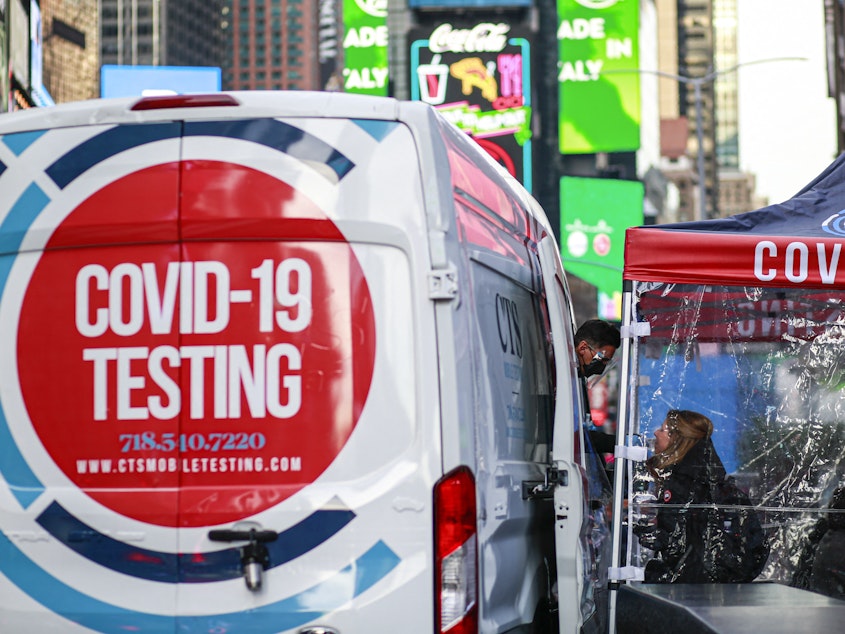 caption: A COVID-19 testing site is pictured in Times Square, New York city on December 5, 2021.