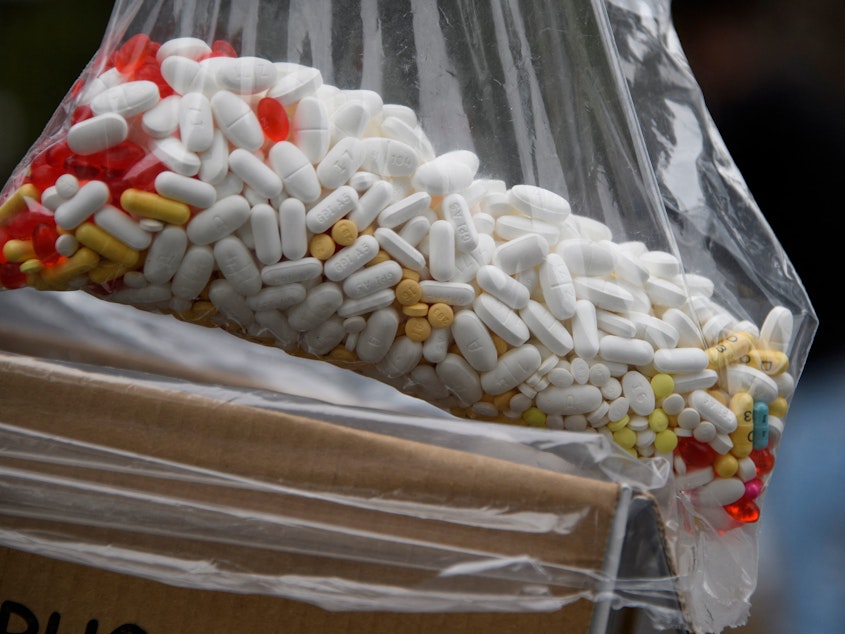 caption: A bag of assorted pills and prescription drugs dropped off for disposal is displayed during the Drug Enforcement Administration's 20th National Prescription Drug Take Back Day earlier this year in Los Angeles. According to the Centers for Disease Control and Prevention, more than  100,000 people died of a drug overdose from April 2020 to April 2021.