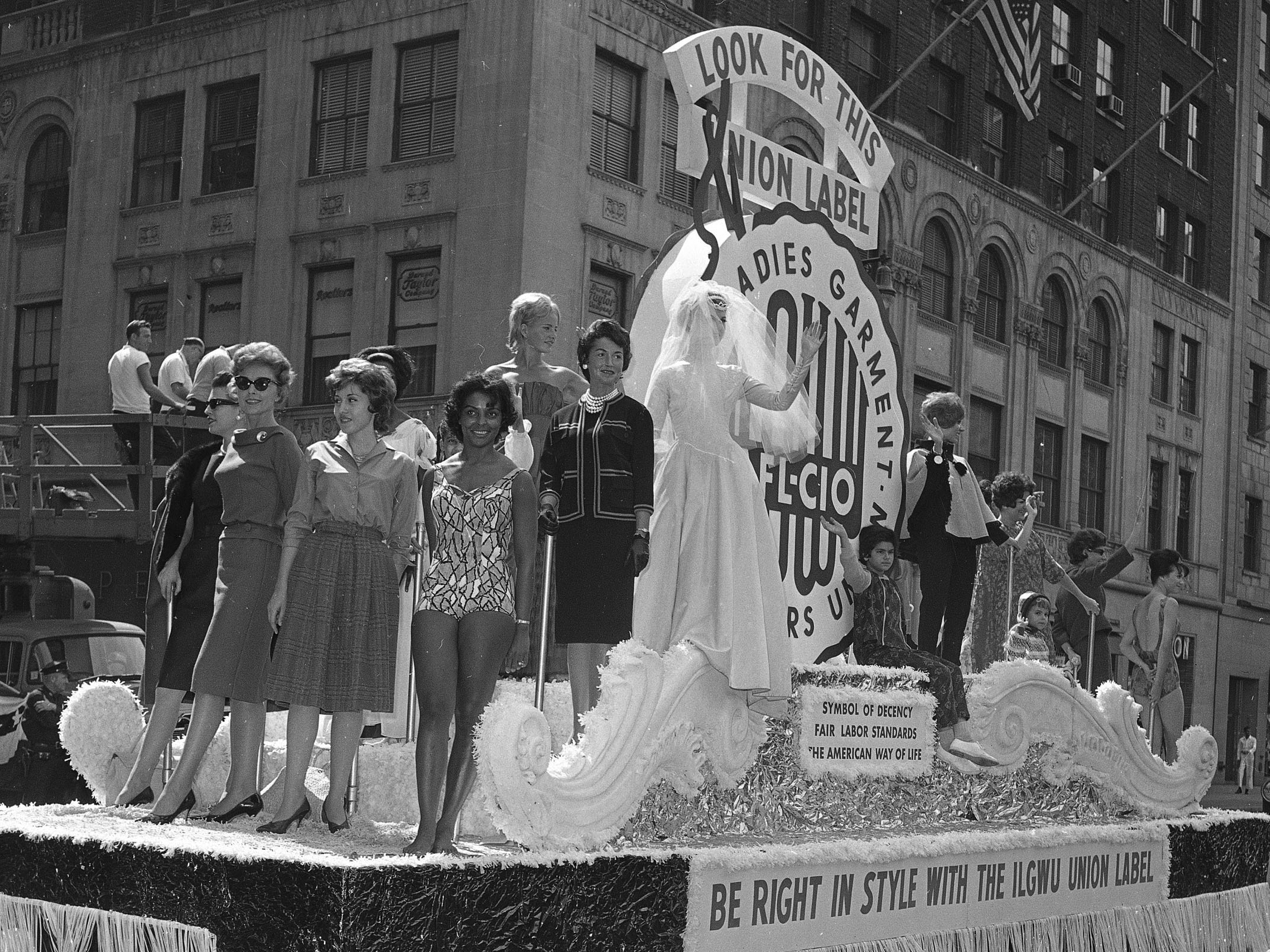 caption: Members of the International Ladies' Garment Workers' Union are seen on a Labor Day parade float, Sept. 4, 1961. While many may associate the holiday with major retail sales and end-of summer barbecues, Labor Day's roots are in worker-driven organizing.