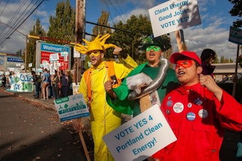 caption: <p>Supporters of Measure 26-201 rally outside of Walmart and U.S. Bank branches in East Portland on Oct. 9, 2018.</p>