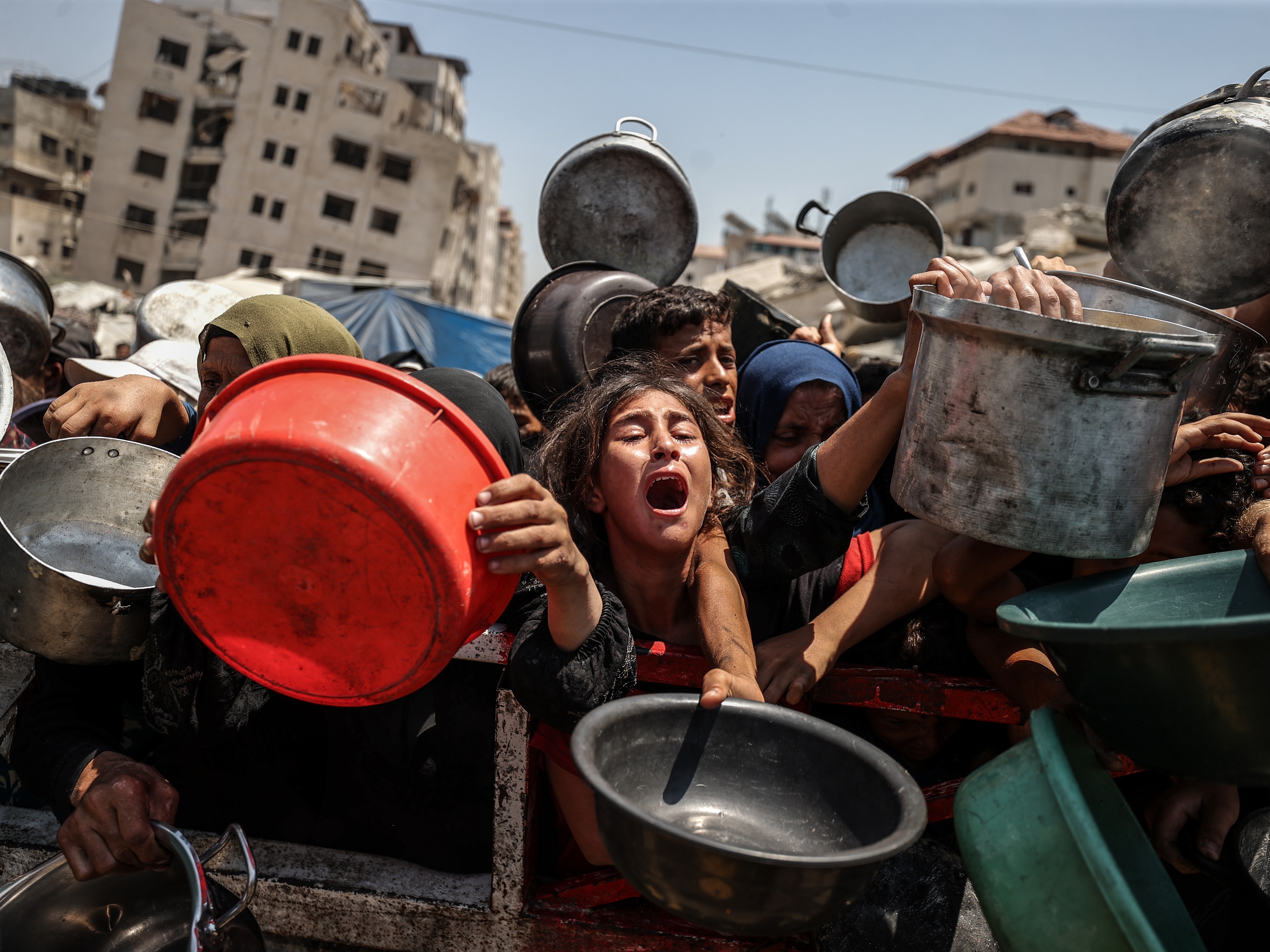 caption: A charity distributes meals to Palestinians facing food shortages amid ongoing Israeli attacks and severe restrictions in Gaza City, Gaza Strip, on Monday.