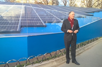 caption: Washington Gov. Jay Inslee, one of the 'super-nationals,' with a solar installation in Paris. 