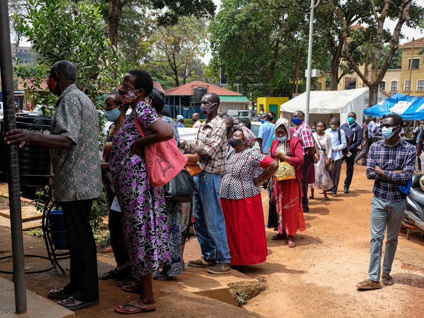 caption: People queue to receive COVID-19 vaccines at a health center in Kampala, Uganda, after weeks of no supply. In Uganda, only 2.2% of the population had received one dose of a vaccine as of August 15
