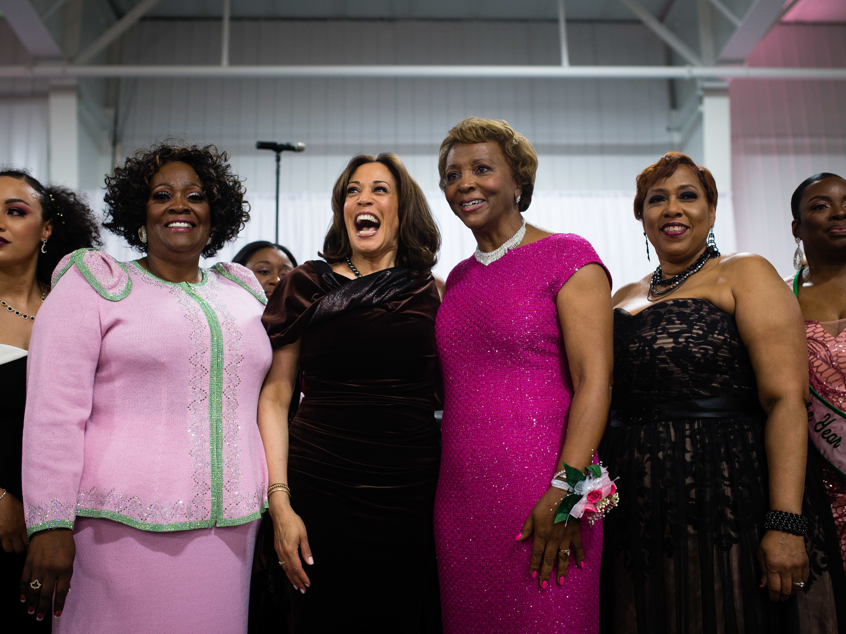 caption: Sen. Kamala Harris stands with attendees and participates in the Alpha Kappa Alpha Sorority Inc. hymn at their Annual Pink Ice Gala in Columbia, South Carolina on Friday, Jan. 25, 2019.