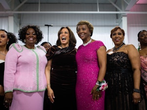 caption: Sen. Kamala Harris stands with attendees and participates in the Alpha Kappa Alpha Sorority Inc. hymn at their Annual Pink Ice Gala in Columbia, South Carolina on Friday, Jan. 25, 2019.
