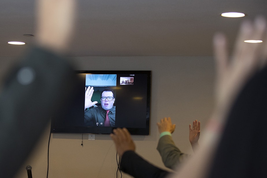 caption: Pastor Carlos Galdamez is shown on Skype during a church service in the basement of Nathan Roberts' home, on Sunday, September 16, 2018, in Des Moines.