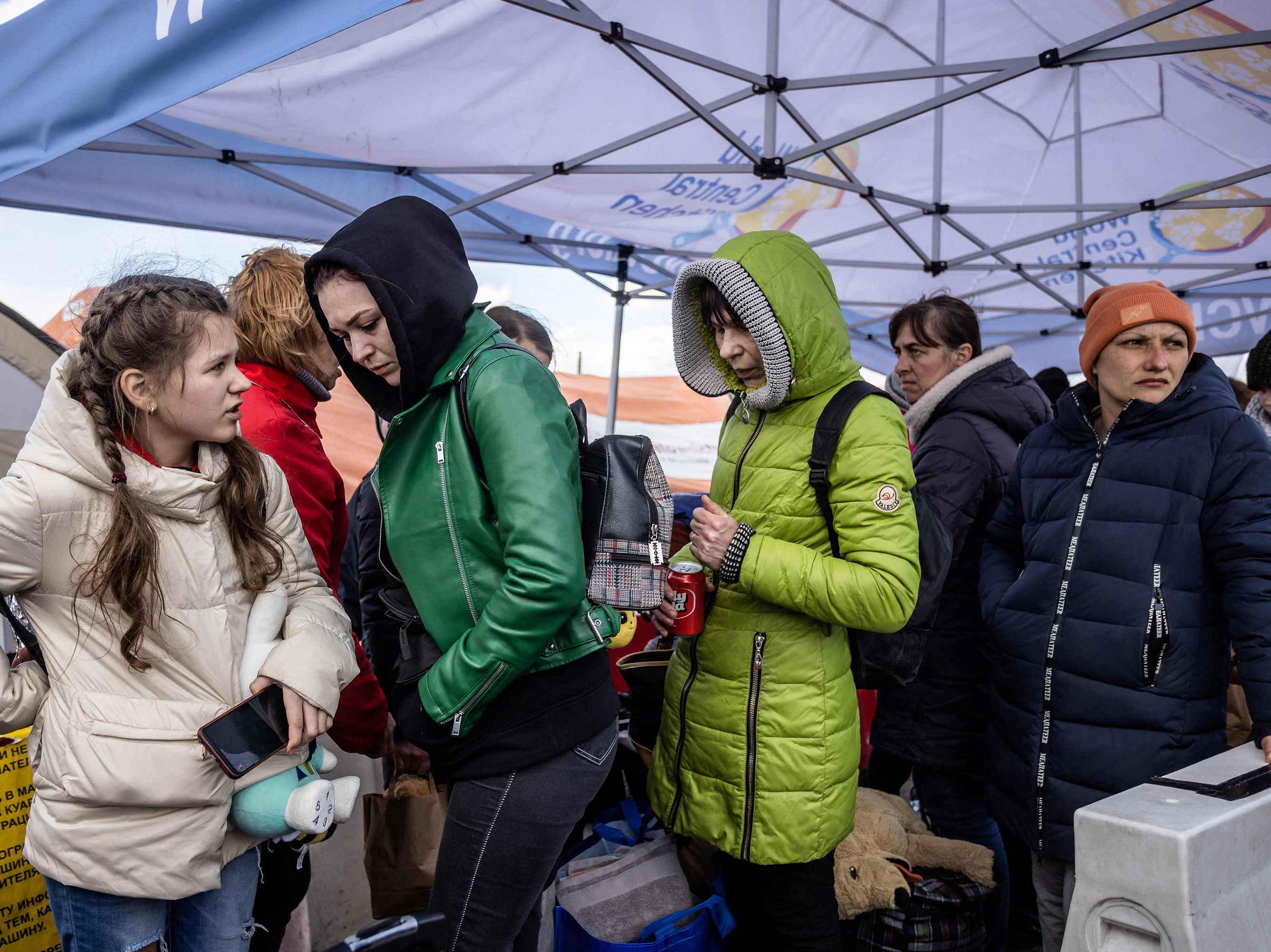caption: Refugees from Ukraine wait for a bus in Medyka, southeastern Poland, on April 8 after having crossed the Ukraine-Poland border.
