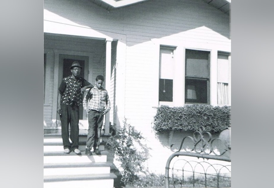 caption: Author Walter Mosley and his father in front of their home in the Watts neighborhood of Los Angeles. 