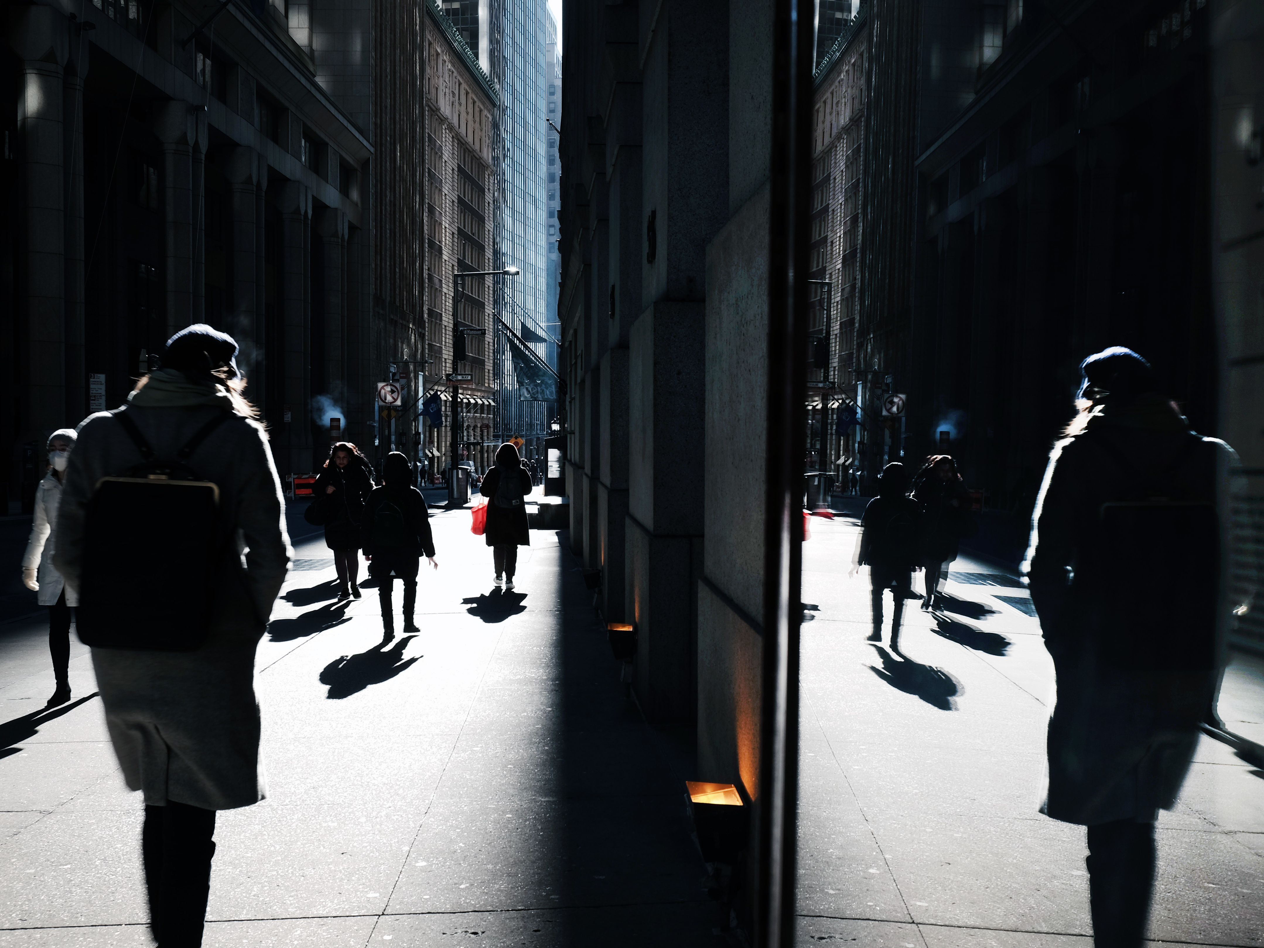 caption: People walk along Wall Street near the New York Stock Exchange, in New York City. The stock market has been volatile as the war in Ukraine and high oil prices continues to worry investors. Americans' stress about global uncertainty is high, according to a new survey.