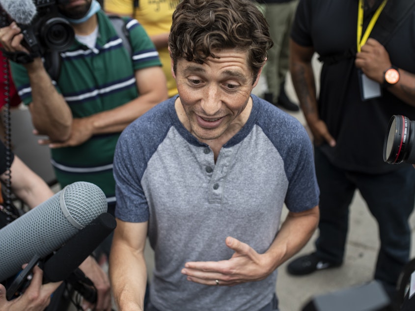 caption: Minneapolis Mayor Jacob Frey speaks with demonstrators calling for the Minneapolis Police Department to be defunded on June 6, 2020.