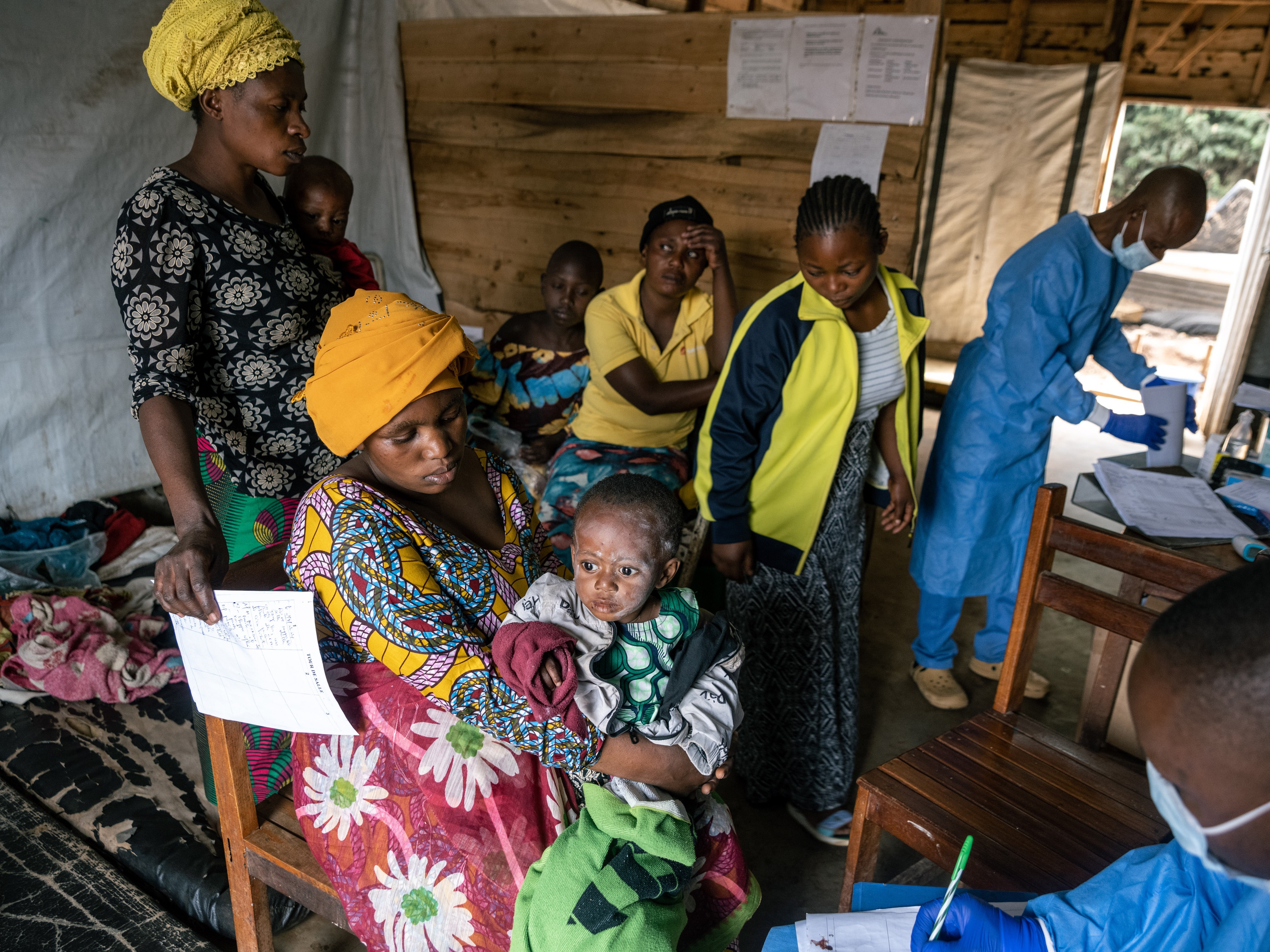 caption: A doctor discusses treatment for mpox with the mother of an infected infant at the Kavumu hospital in the Democratic Republic of Congo. For 18 months, the Congolese have struggled to control an epidemic of the disease without the benefit of vaccines.  The majority of cases and deaths have been in children.  