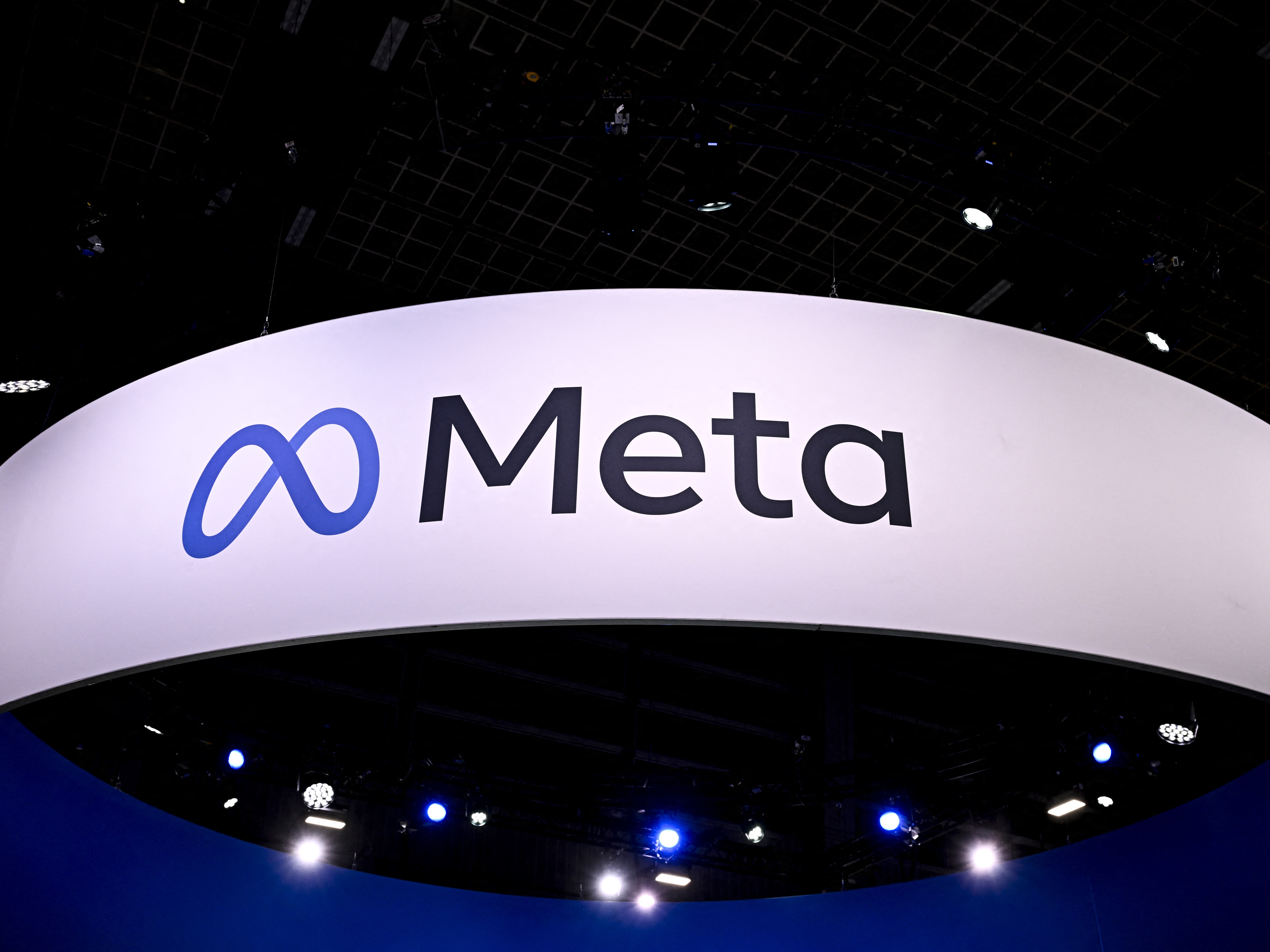 caption: The Meta logo at a trade fair in France earlier this year. The social media firm says it has disrupted more accounts tied to Iranian hackers who are targeting the U.S. presidential election.
