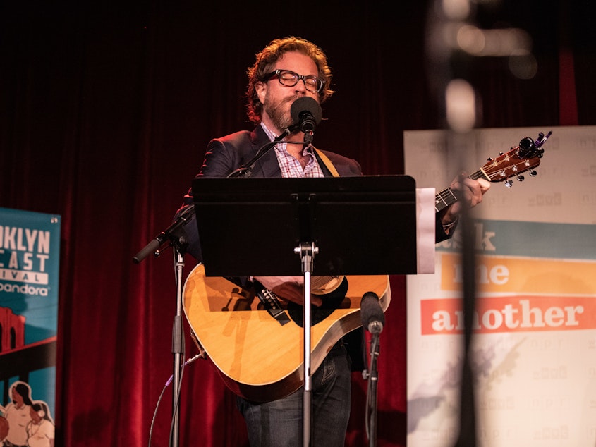caption: <em>Ask Me Another</em>'s house musician Jonathan Coulton leads a music parody game at the Bell House in Brooklyn, New York.