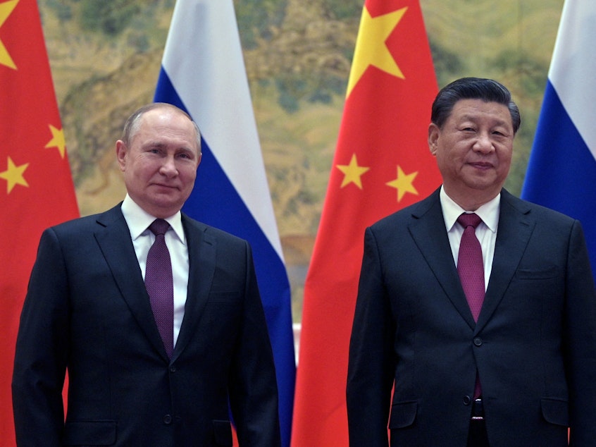 caption: Russian President Vladimir Putin and Chinese President Xi Jinping pose during their meeting in Beijing, on February 4.