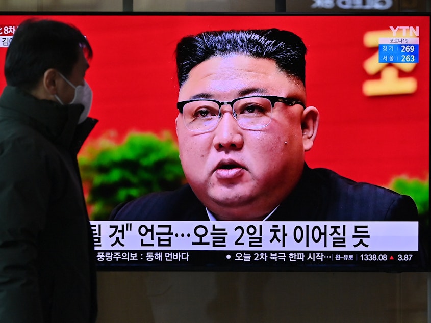 caption: A man watches a television screen at a railway station in Seoul on Wednesday showing news footage of North Korean leader Kim Jong Un attending the 8th Congress of the ruling Workers' Party held in Pyongyang.
