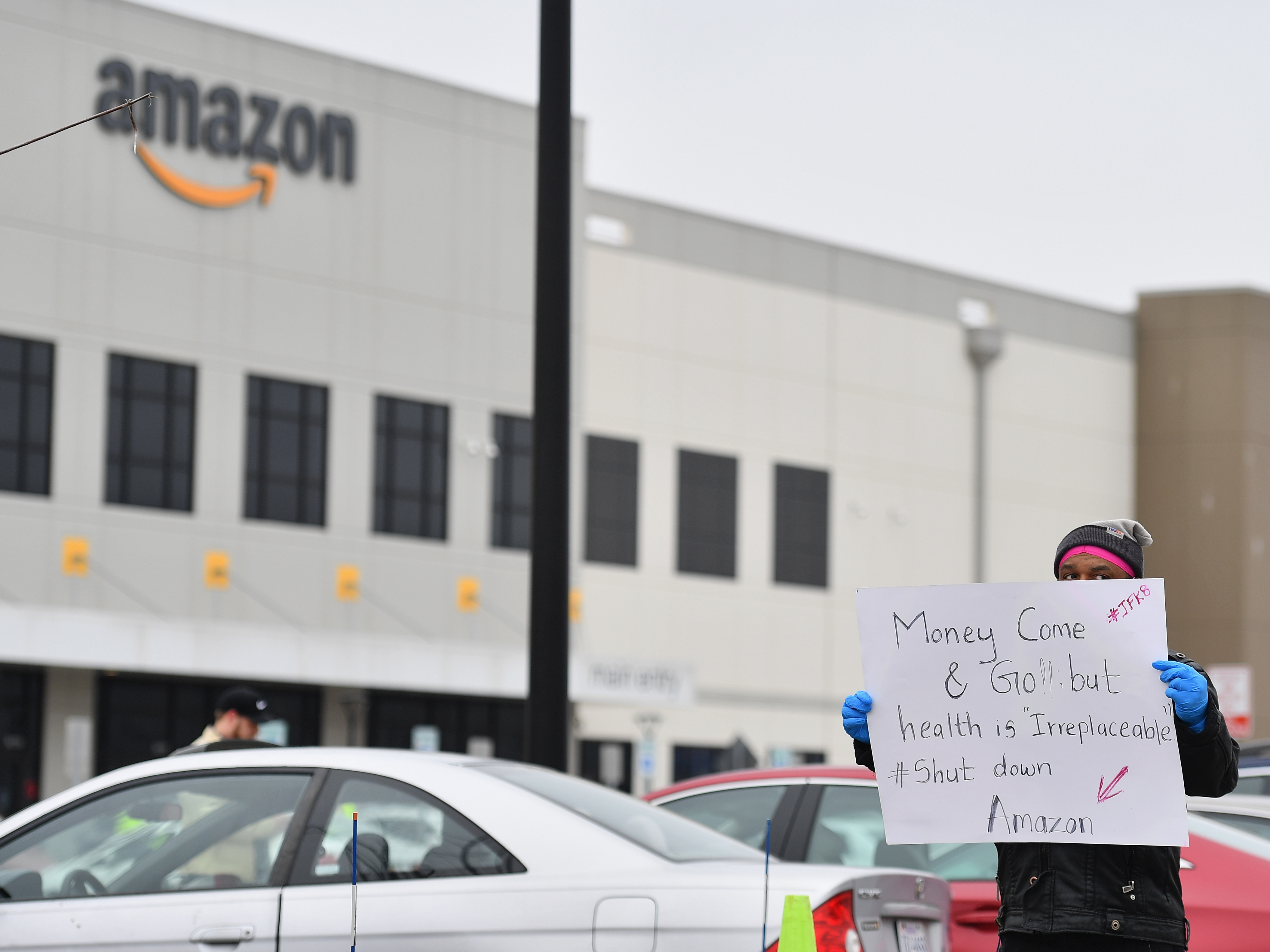 caption: Amazon workers at a Staten Island warehouse stage a protest on March 30.