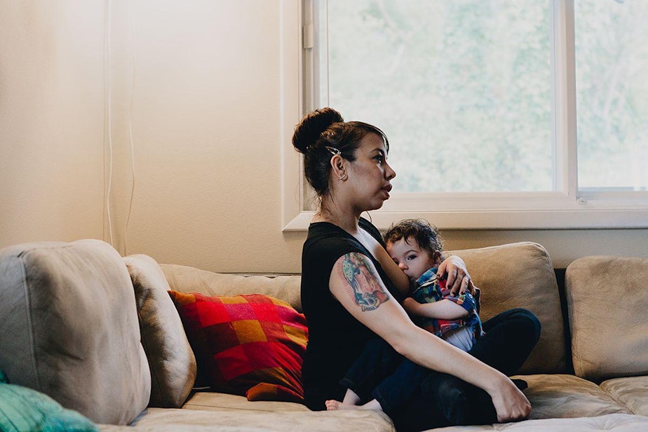 caption: Nadia Rodriguez breastfeeds her son Rio, 20 months, at their home in Rainier Beach.