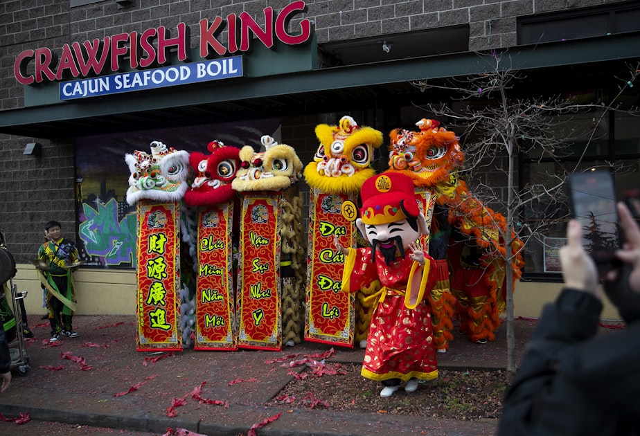 caption: Mak Fai Dragon and Lion dancers pose for a picture after performing during the Lunar New Year celebration on Saturday, Feb. 4, 2023, in Seattle’s Chinatown-International District.