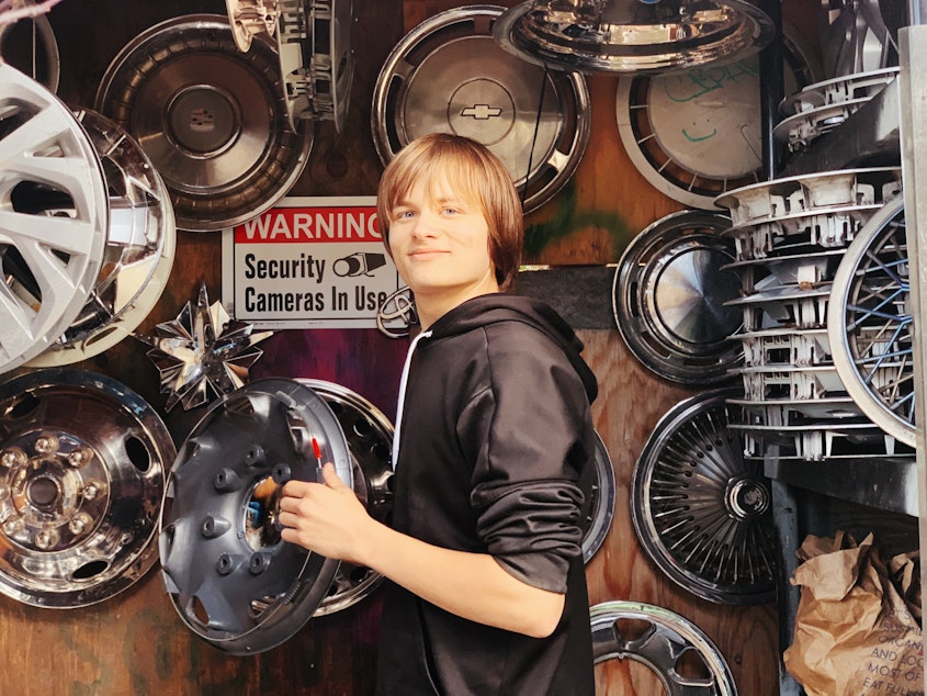 caption: Michael Sheeran with his hubcap collection. He creates videos for his YouTube channel, Hubcaps219.