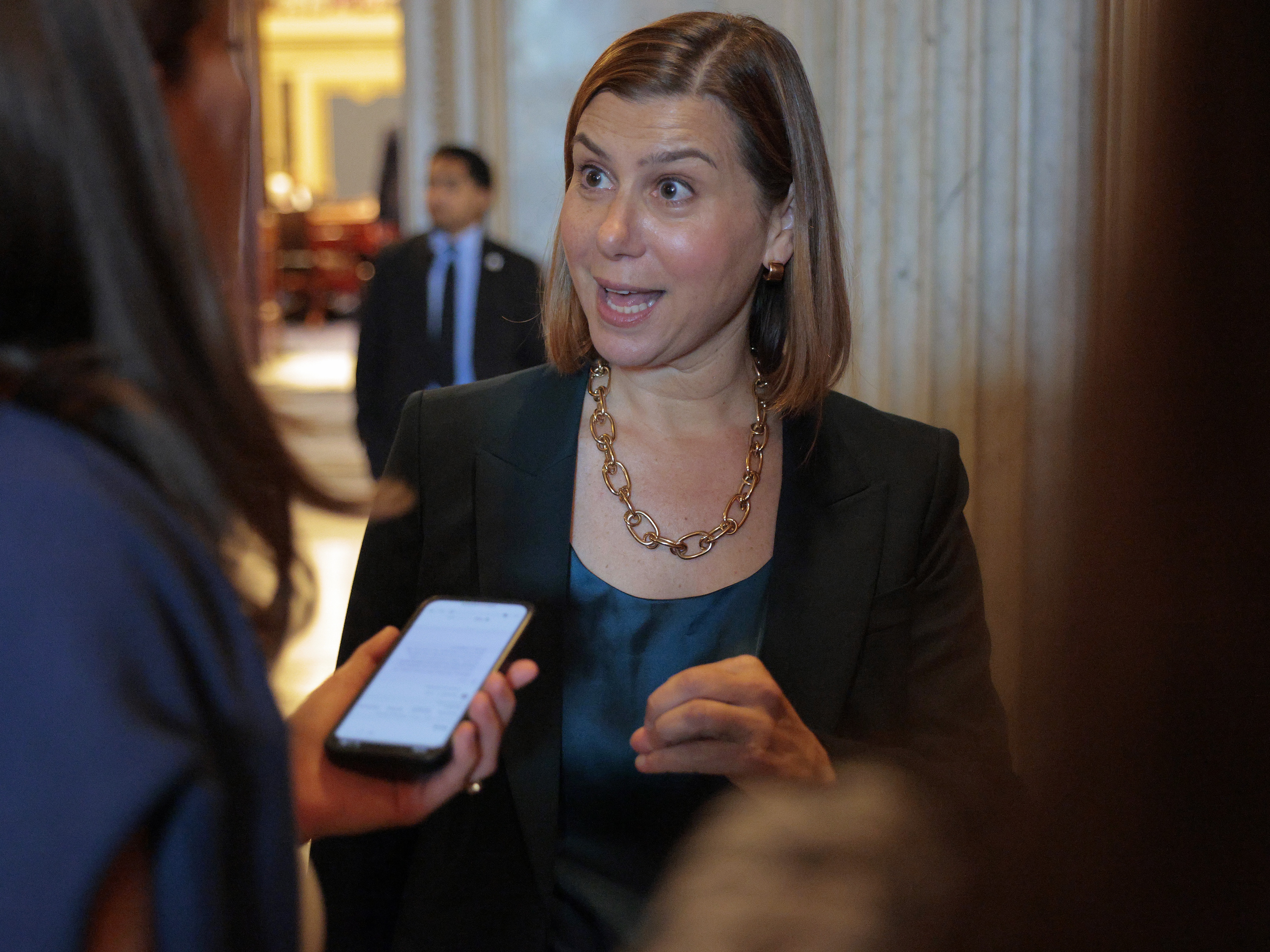 caption: Sen. Elissa Slotkin, D-Mich., speaks to a reporter following a vote at the U.S. Capitol on Aug. 1, 2025.