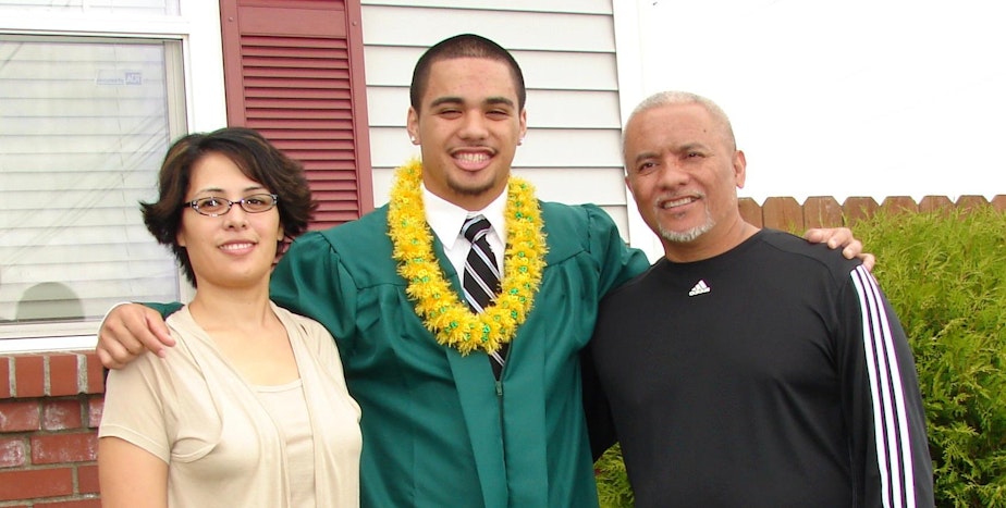 caption: E.J. Strickland, dressed for graduation from Auburn High School, with his parents, Kathleen Keliikoa-Strickland and Enosa Strickland Sr.