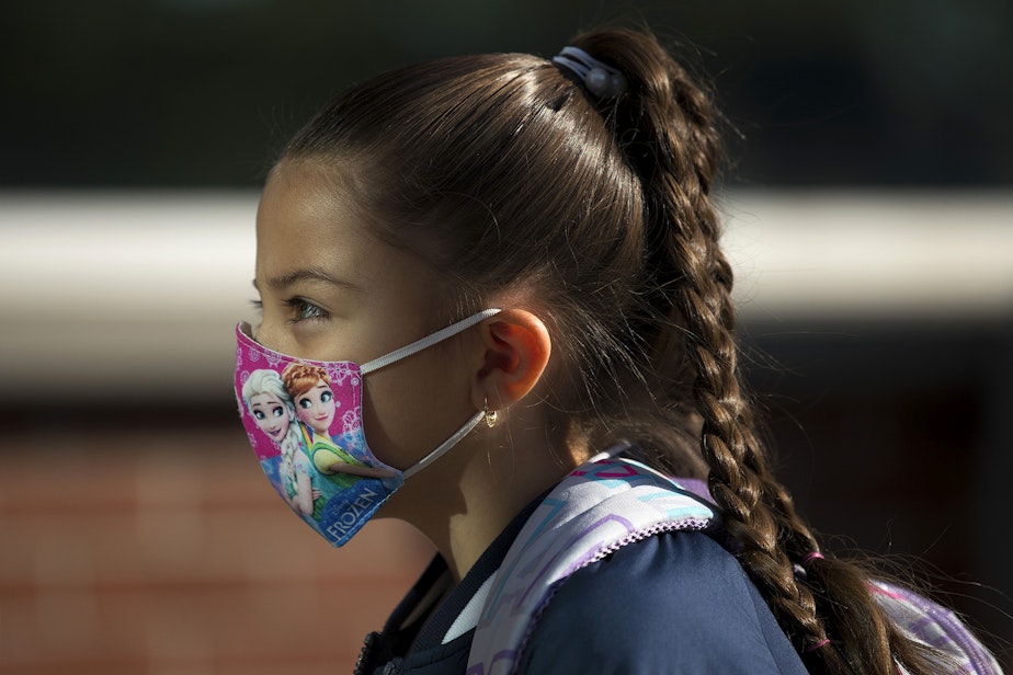 caption: Ximena Vaca Torres, 8, walks into her first day of 3rd grade at Mount View Elementary school on Thursday, September 2, 2021, in Seattle.