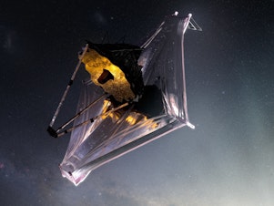 caption: This illustration shows the James Webb Space Telescope as it might appear as it orbits the sun, about a million miles away from Earth.