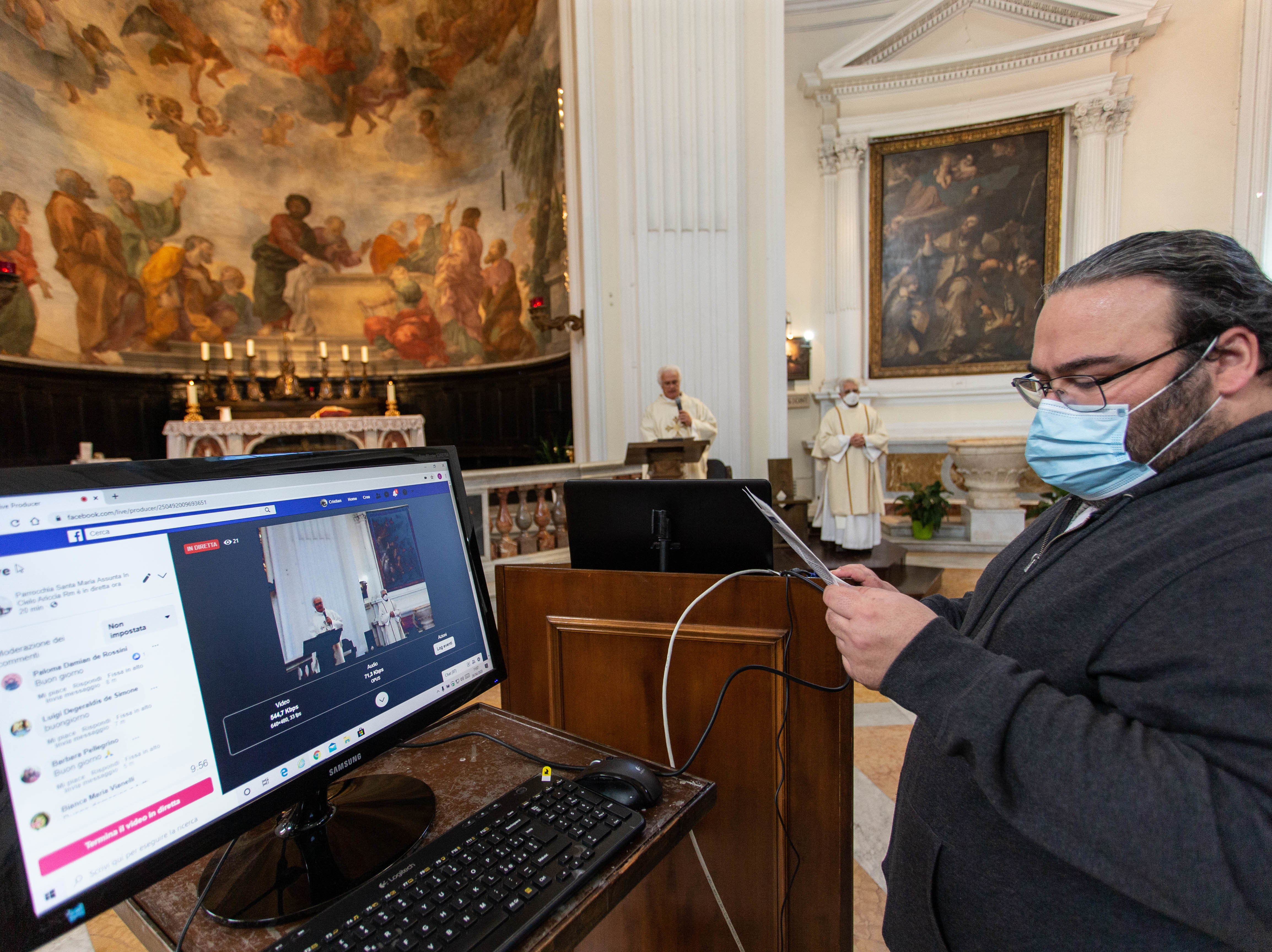 caption: A technician sets up a livestream in Rome's empty Santa Maria Assunta in Cielo church on Sunday. Italy's prime minister has announced a gradual ending of restrictions in the hard-hit country.
