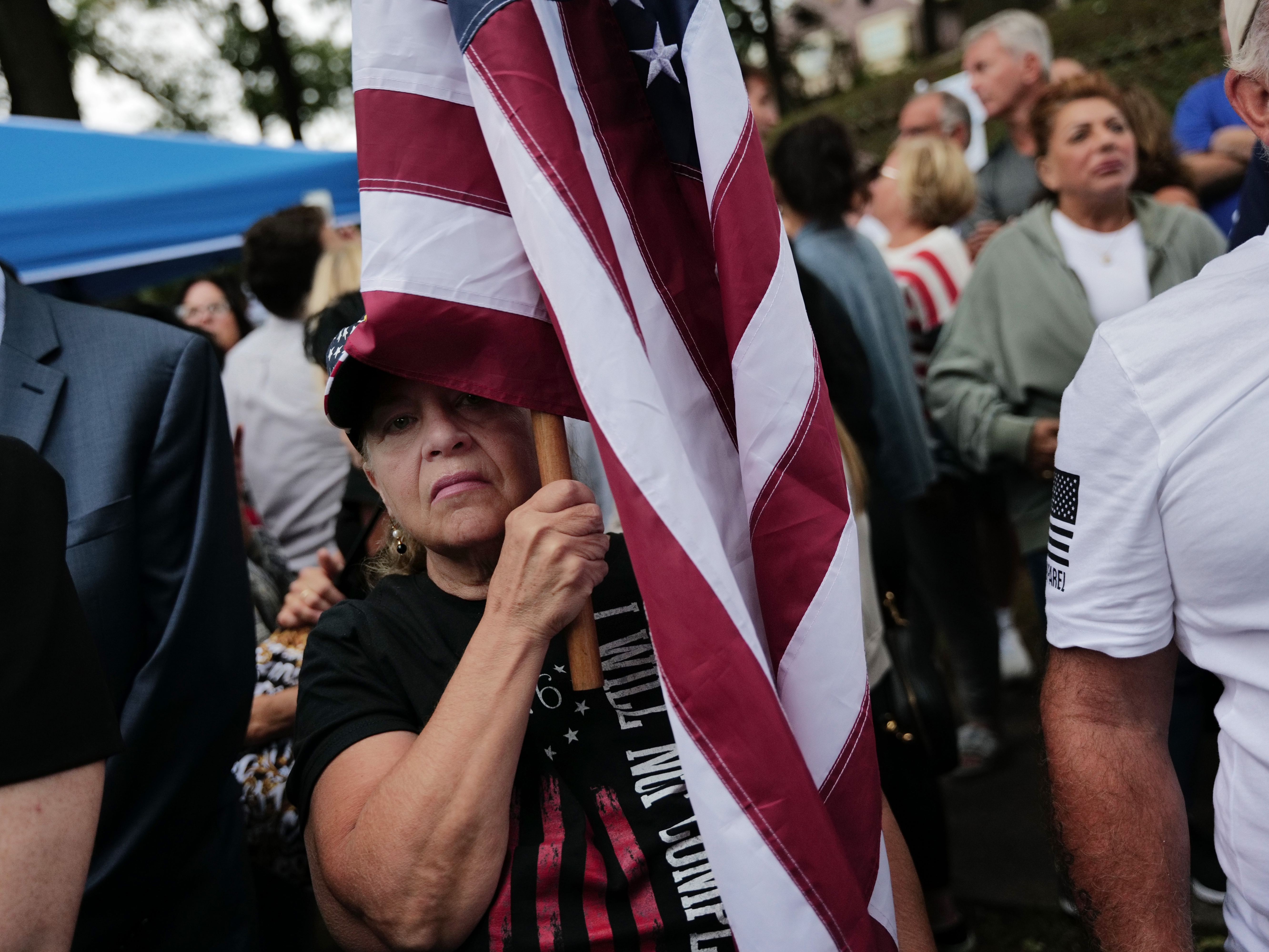 caption: Staten Island residents protest outside a closed Catholic school-turned-migrant shelter on Staten Island, N.Y., on Aug. 28.