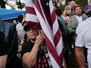 caption: Staten Island residents protest outside a closed Catholic school-turned-migrant shelter on Staten Island, N.Y., on Aug. 28.