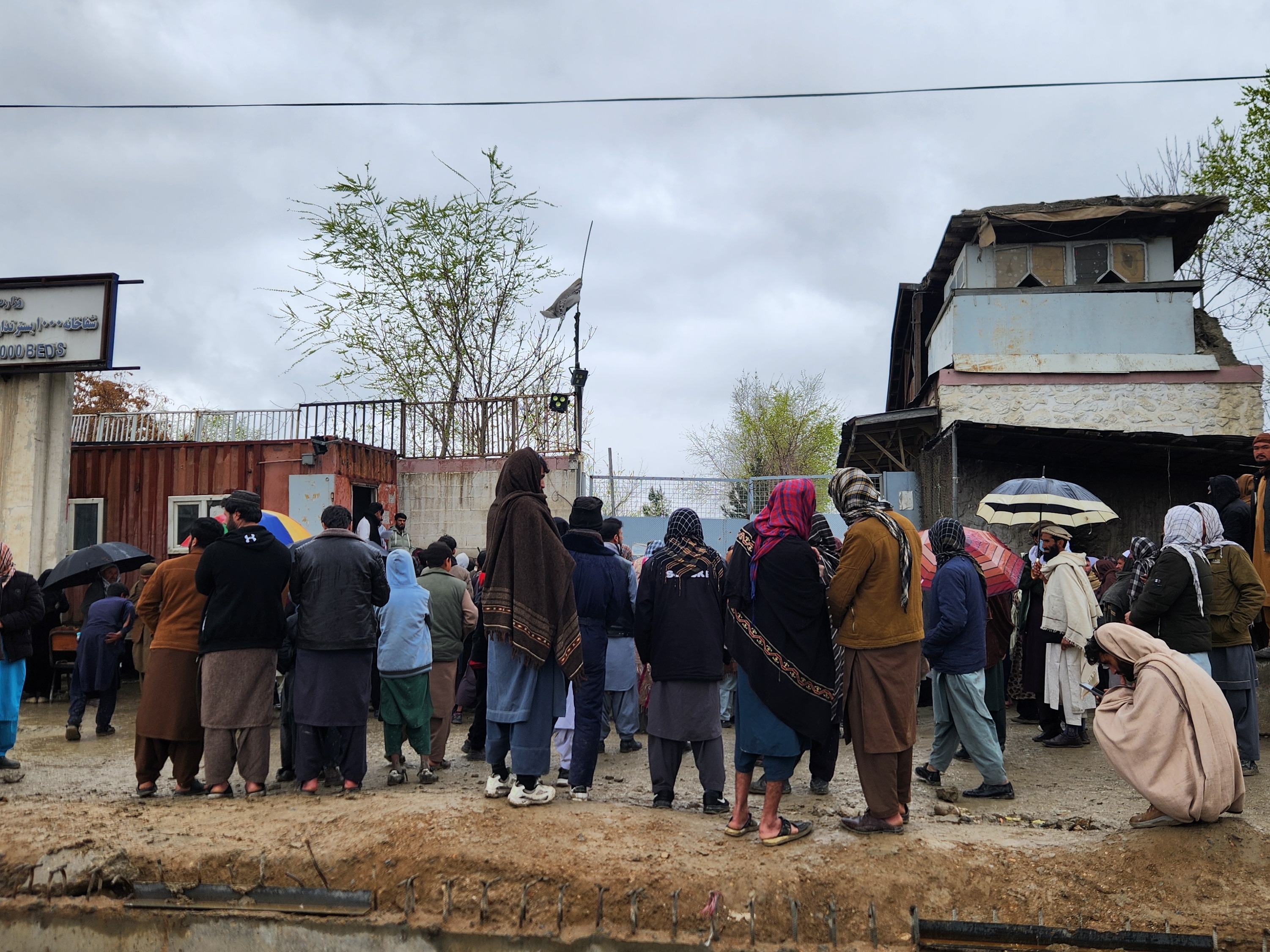 caption: A crowd gathers outside Kabul's Omid Addiction Treatment Hospital, where the United Nations says an airstrike killed more than 100 people on Monday.