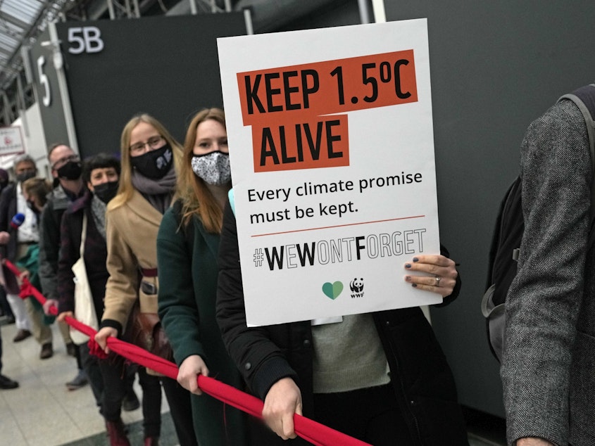 caption: Climate activists demonstrate at the COP26 U.N. Climate Summit in Glasgow, Scotland, Friday. Negotiators from almost 200 nations were making a fresh push to reach agreement on a series of key issues.