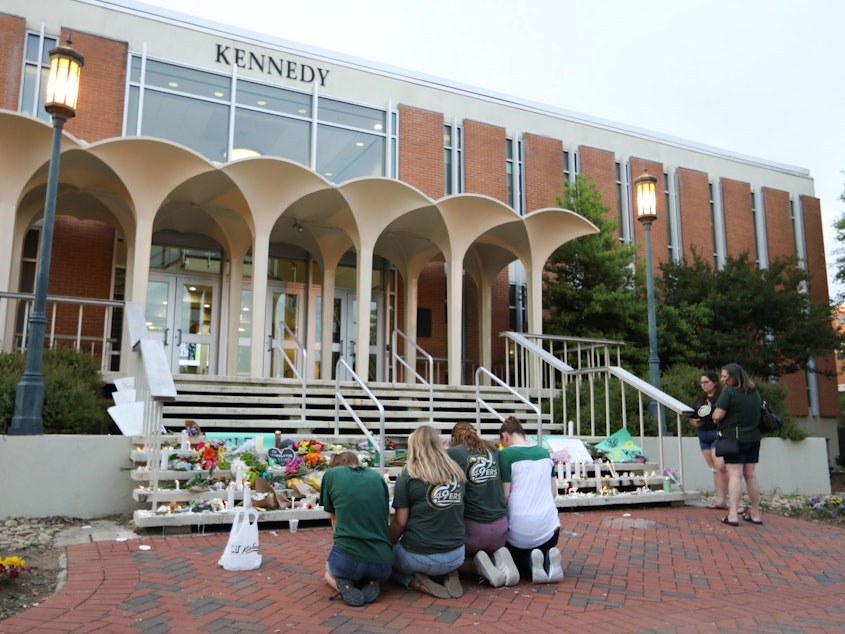 caption: Students and faculty honor the victims of a shooting at the University of North Carolina Charlotte.