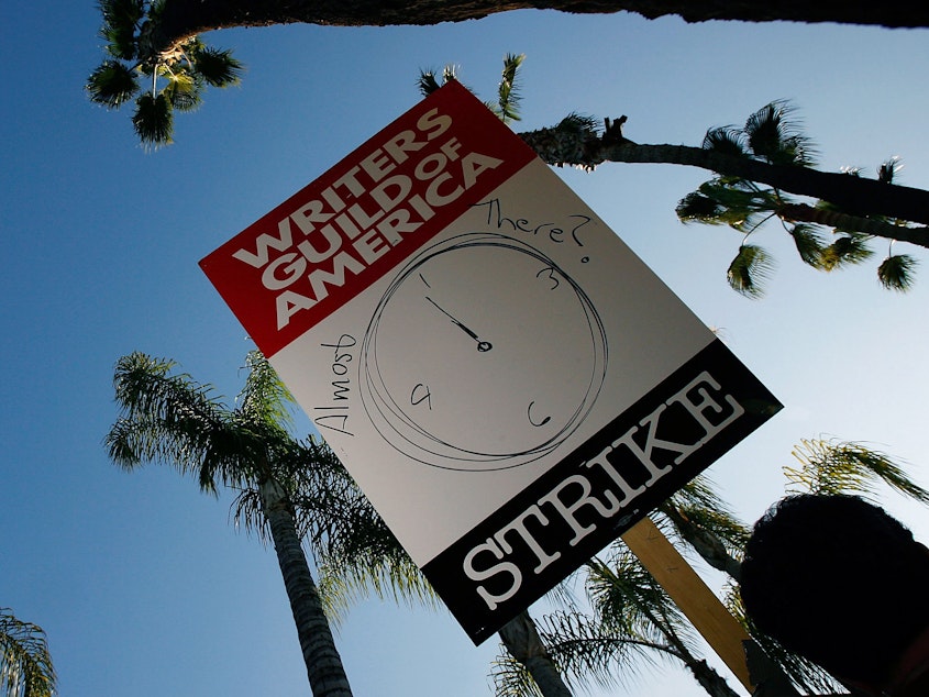 caption: Writers Guild of America members and supporters picket in front of NBC studios ahead of proposed contract in February 2008.