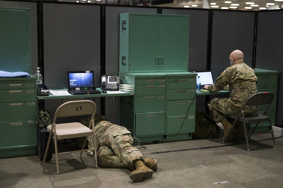 caption: U.S. Army soldiers set up the laboratory area of a military field hospital inside CenturyLink Field Event Center on Sunday, April 5, 2020, in Seattle. The 250-bed hospital for non COVID-19 patients was deployed by soldiers from the 627th Army Hospital from Fort Carson, Colorado, as well as soldiers from Joint Base Lewis-McChord.