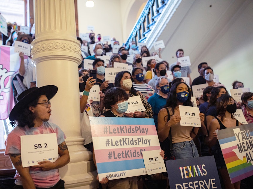 caption: LGBTQ rights advocates protest efforts to pass legislation restricting the participation of trans student athletes on Sept. 20 at the Texas State Capitol in Austin, Texas. Gov. Greg Abbott signed the bill into law Monday.