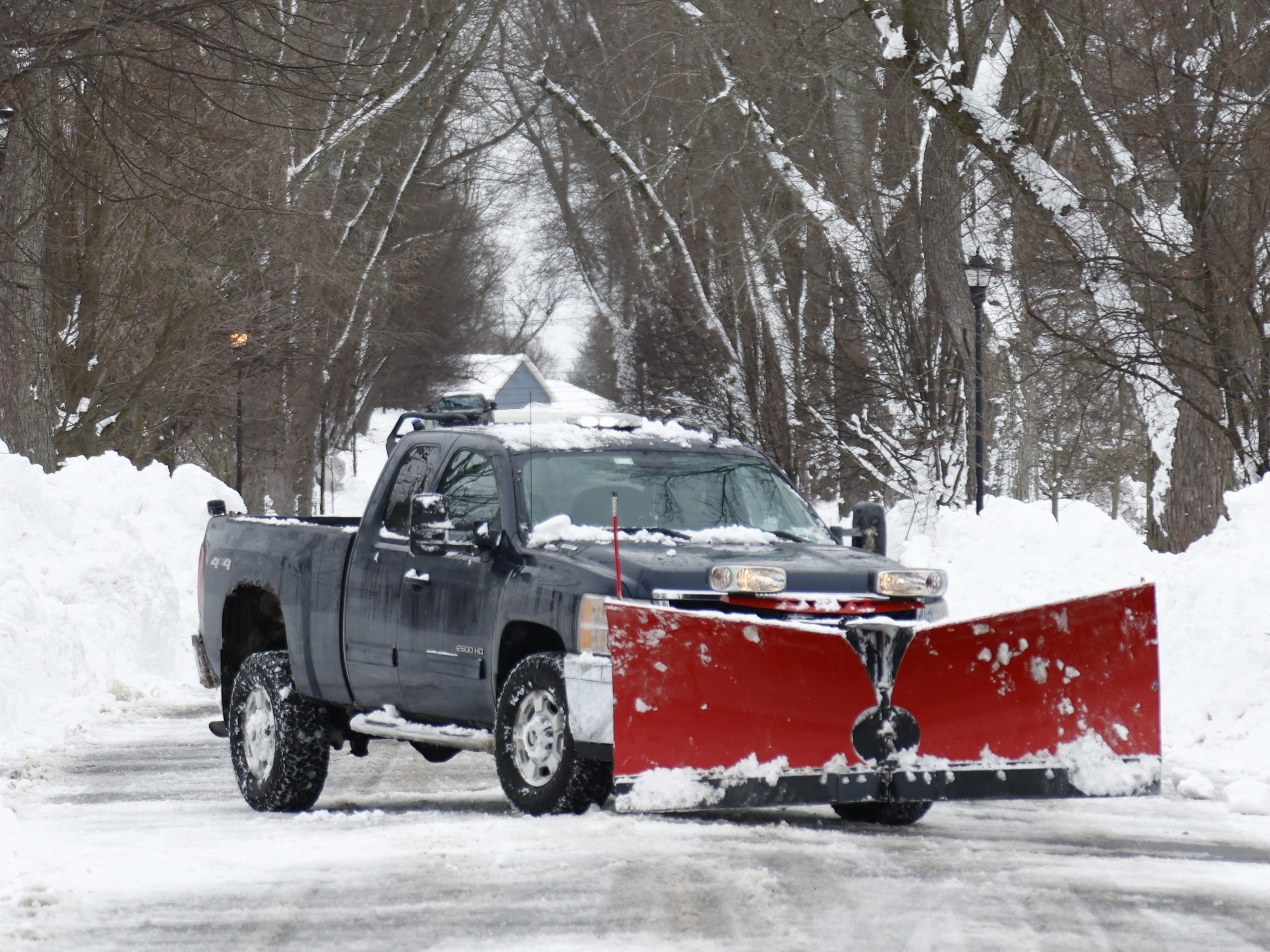 caption: A plow clears snow after a winter storm rolled through Western New York Tuesday, Dec. 27, 2022, in Amherst, N.Y.