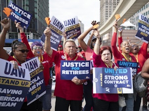 caption: UAW members attend a solidarity rally as the UAW strikes the Big Three automakers on September 15, 2023 in Detroit. GM announced temporary layoffs on Wednsday, blaming the strikes.