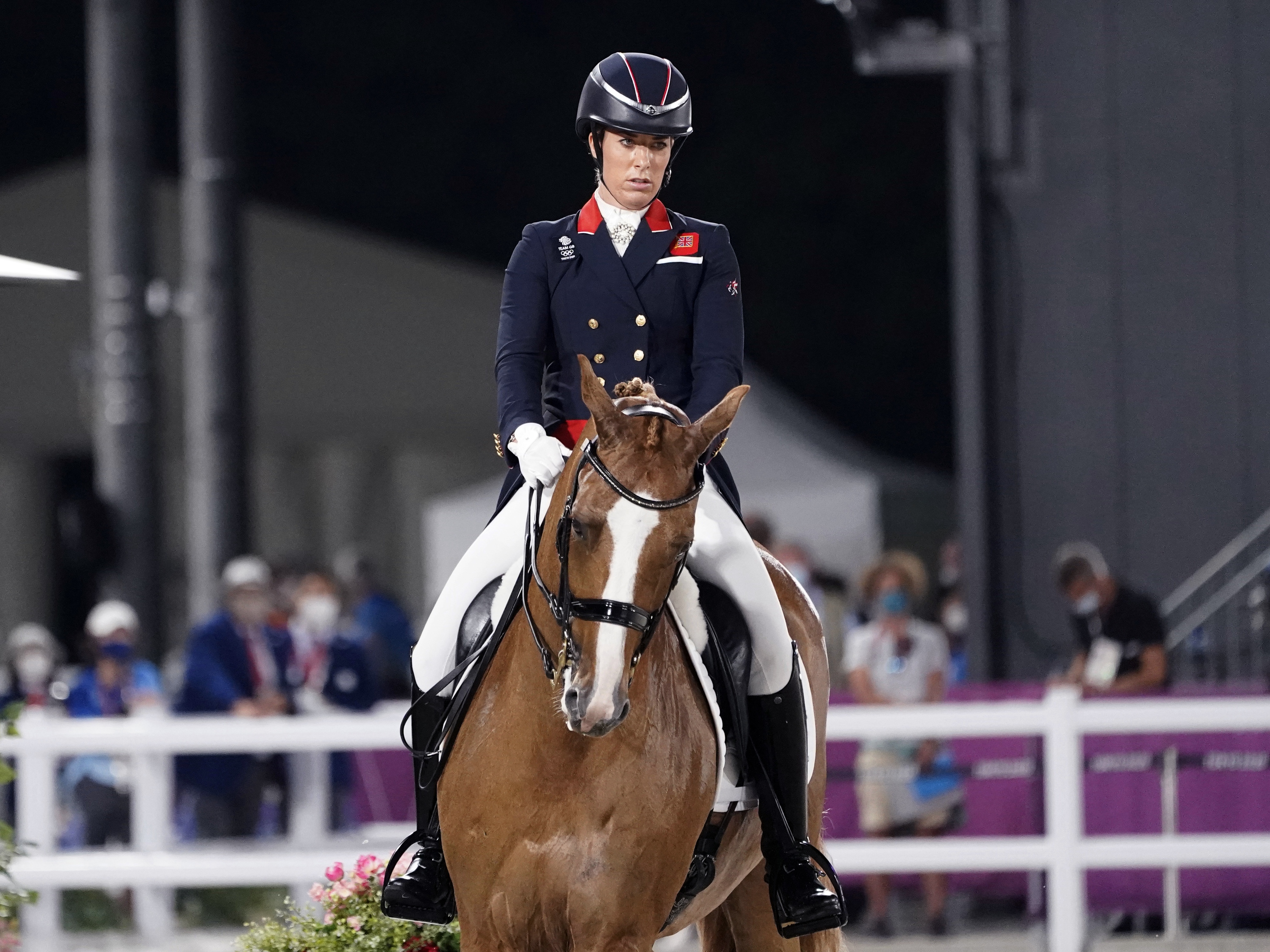 caption: Britain's Charlotte Dujardin competes in the equestrian dressage individual final at the Tokyo Summer Olympics on July 28, 2021. Dujardin has withdrawn from the Paris Games after a video emerged that she says shows her behaving inappropriately while coaching other riders.