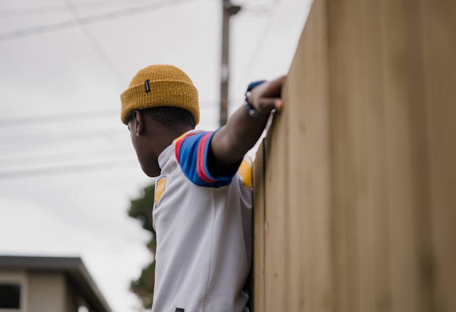 caption: Getahun balances on a garden bed on Sunday, March 13, 2022, in Seattle, Washington. Getahun, now 13, was adopted as an infant from Ethiopia by a Washington state couple. His former adoptive mother, Kyle Wohlers, was criminally charged for abusing him in 2021. The case was dropped a year later, after a prosecutor determined that Getahun was not mentally well enough to testify during a trial.