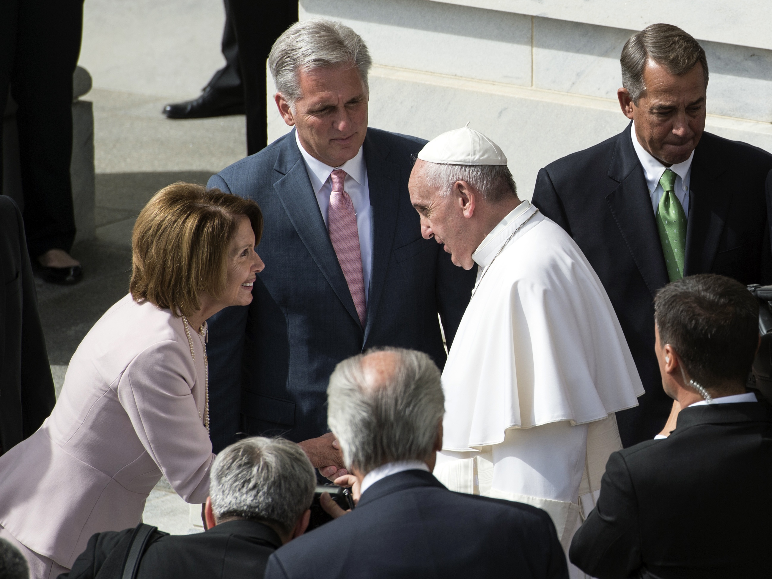 caption: Rep. Nancy Pelosi shakes hands with Pope Francis on Capitol Hill in September 2015.
