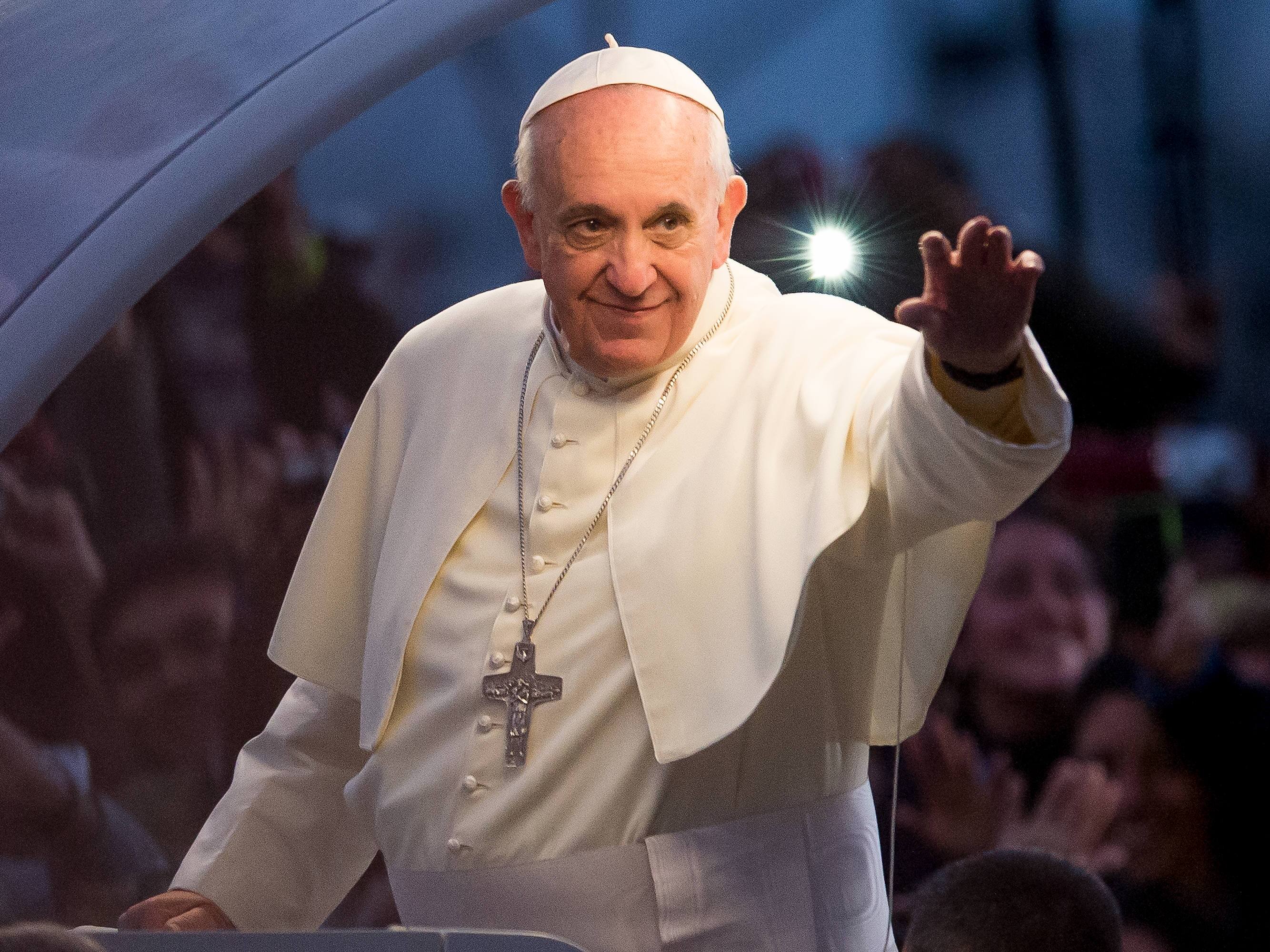 caption: Pope Francis waves from the Popemobile in Rio de Janeiro, Brazil.