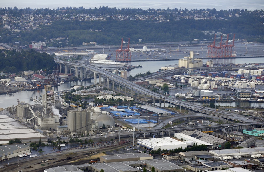 caption: Aerial photo of the Port of Seattle, the West Seattle Bridge, and the Ash Grove Cement Company. 