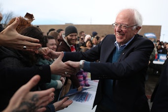 caption: Vermont Sen. Bernie Sanders greets people at a campaign field office in Cedar Rapids, Iowa. Sanders is the slight favorite to win the caucuses, and he hopes it vaults him to the Democratic nomination.