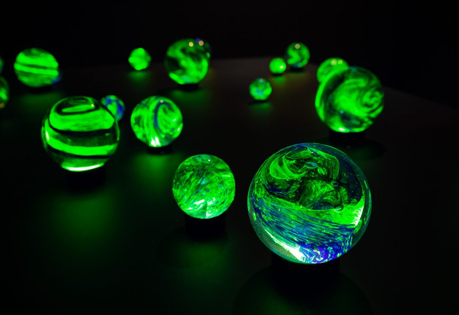 caption: Glass orbs glow in Etsuko Ichikawa's Poems of Broken Fireflies.