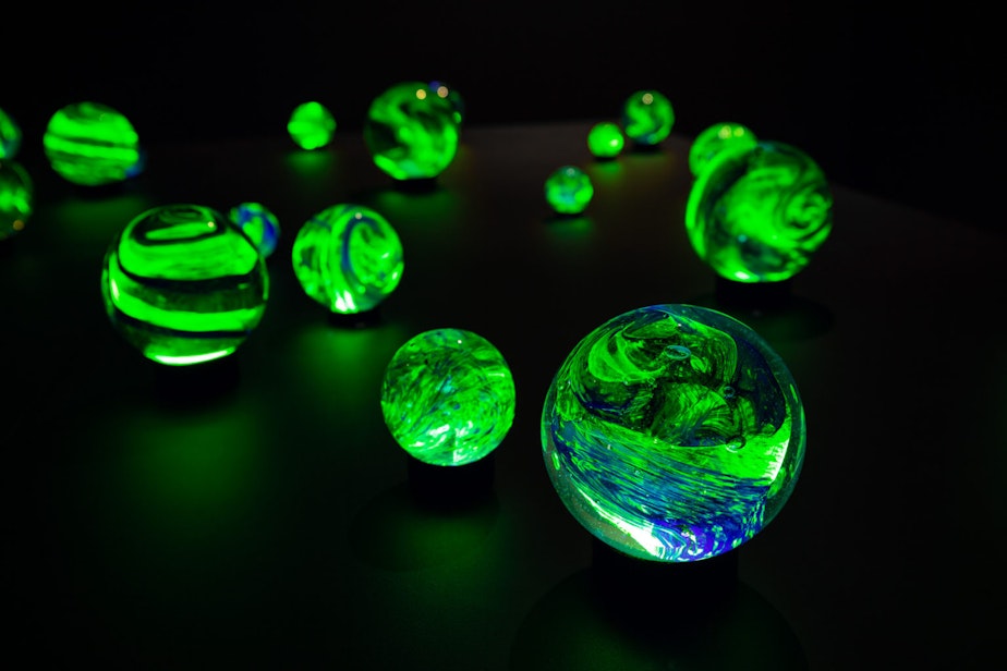 caption: Glass orbs glow in Etsuko Ichikawa's Poems of Broken Fireflies.