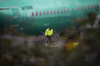 caption: A Boeing employee exits the fuselage of a 737 MAX airplane on Monday, December 16, 2019, in Renton. 