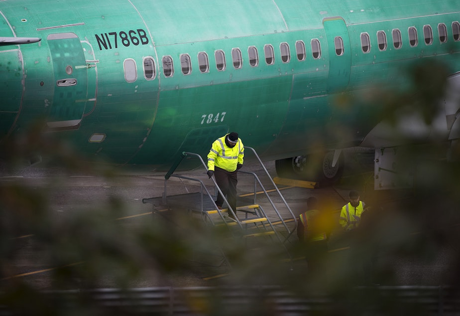 caption: A Boeing employee exits the fuselage of a 737 MAX airplane on Monday, December 16, 2019, in Renton. 