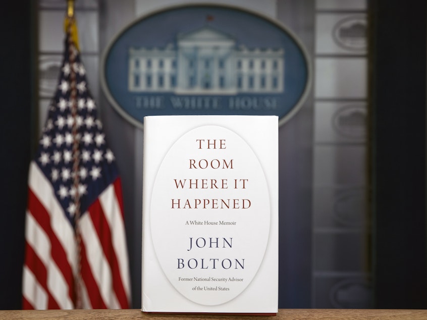 caption: A copy of John Bolton's book, <em>The Room Where It Happened</em>, stands in the White House briefing room. On Saturday, a federal judge declined the Trump administration's request to block the publication of the former national security adviser's book.