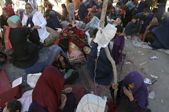 caption: Internally displaced Afghan women from northern provinces, who fled their home due to fighting between the Taliban and Afghan security personnel, receive medical care in a public park in Kabul last Tuesday.
